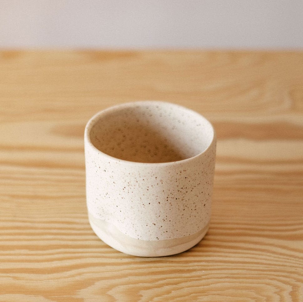 dock colored handmade juice cup on wooden table