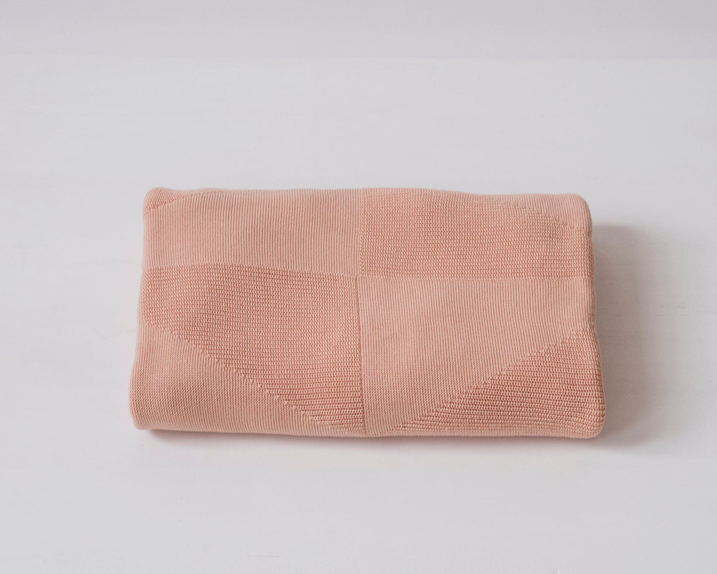 folded peach colored geo panel throw by echoview fiber mill