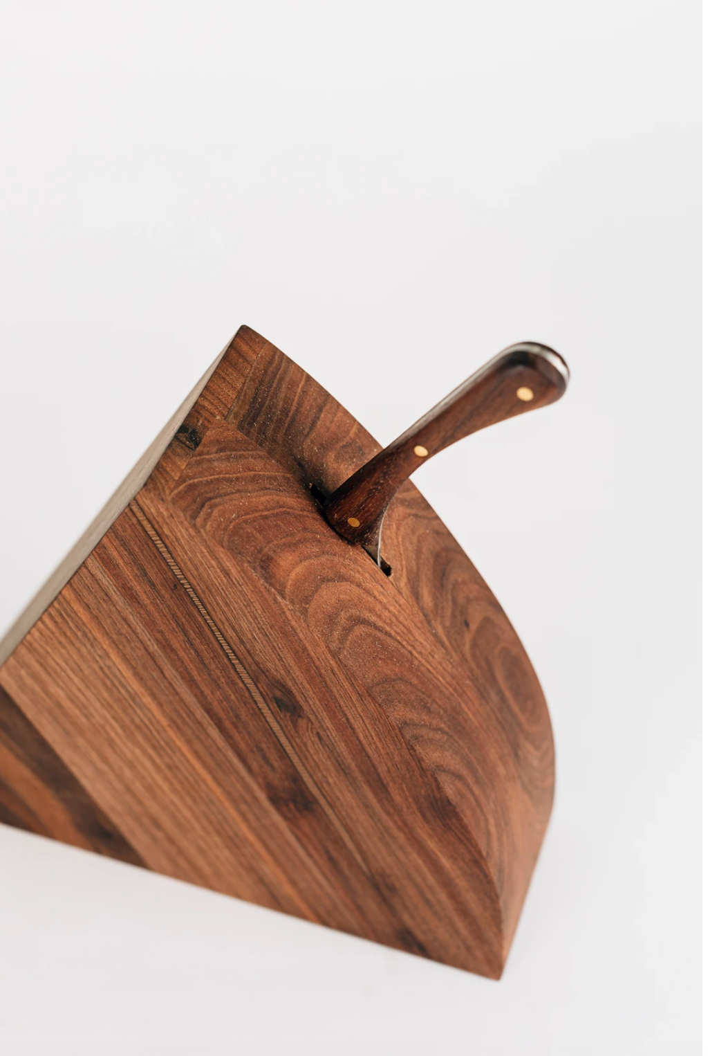 Close up view of storage slot for hand forged knife in walnut cheese block