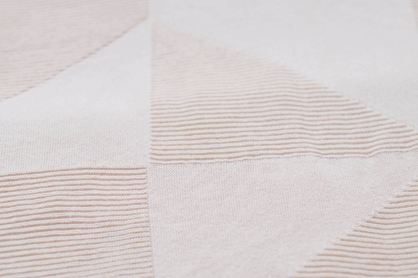 Close up of organic cotton geo panel throw pattern