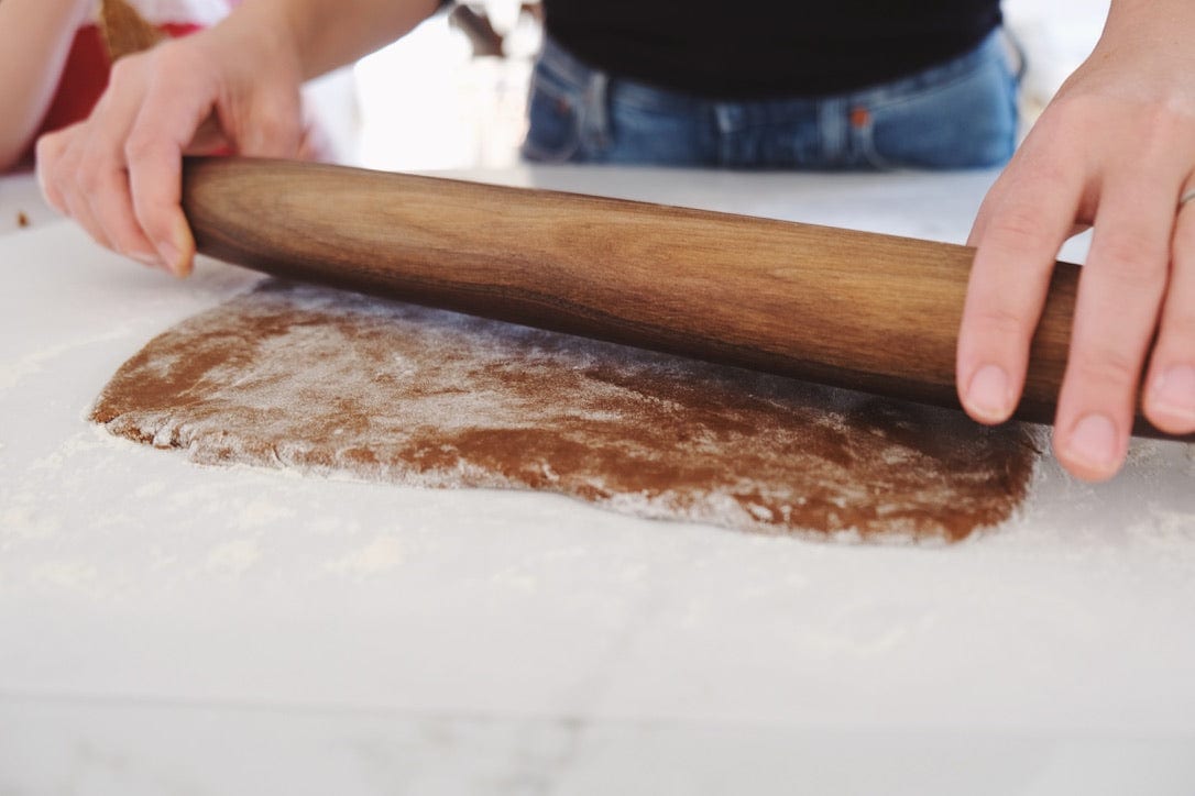 walnut french rolling pin rolling out dough