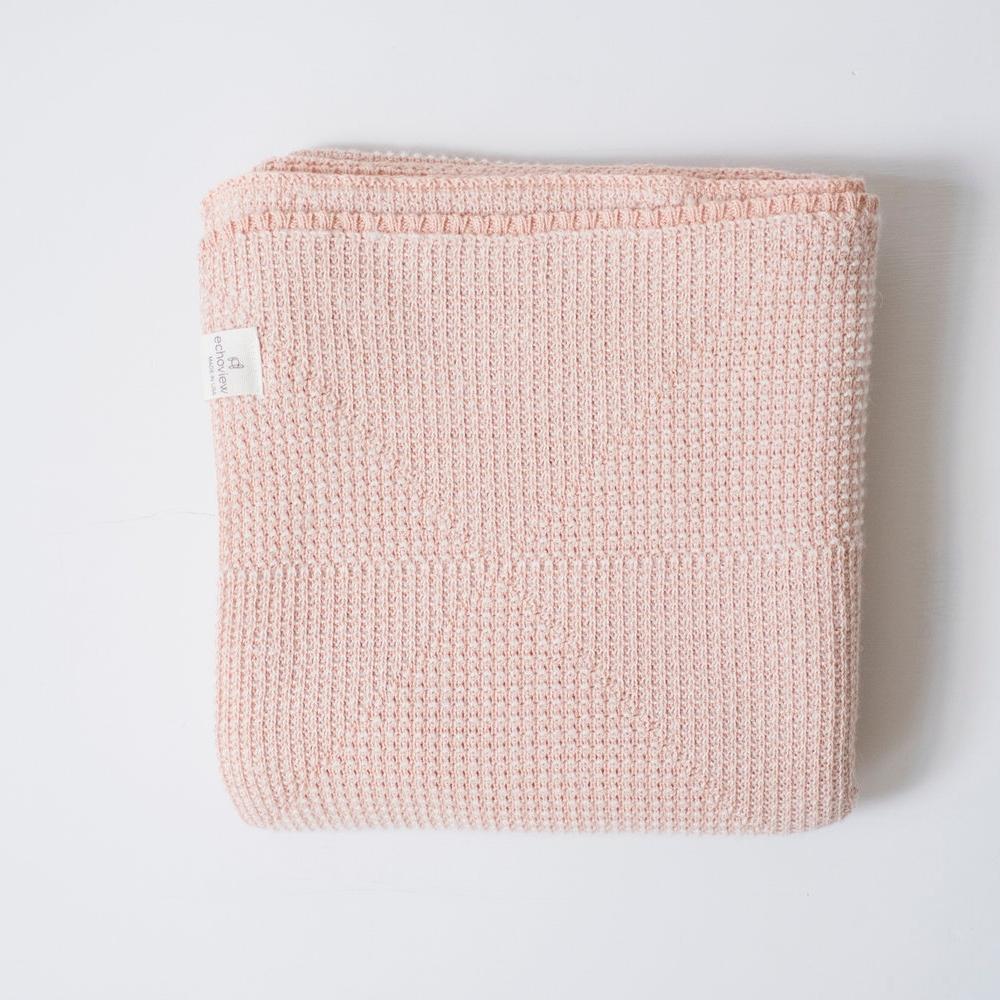 folded organic cotton and alpaca textured triangle baby blanket in peach