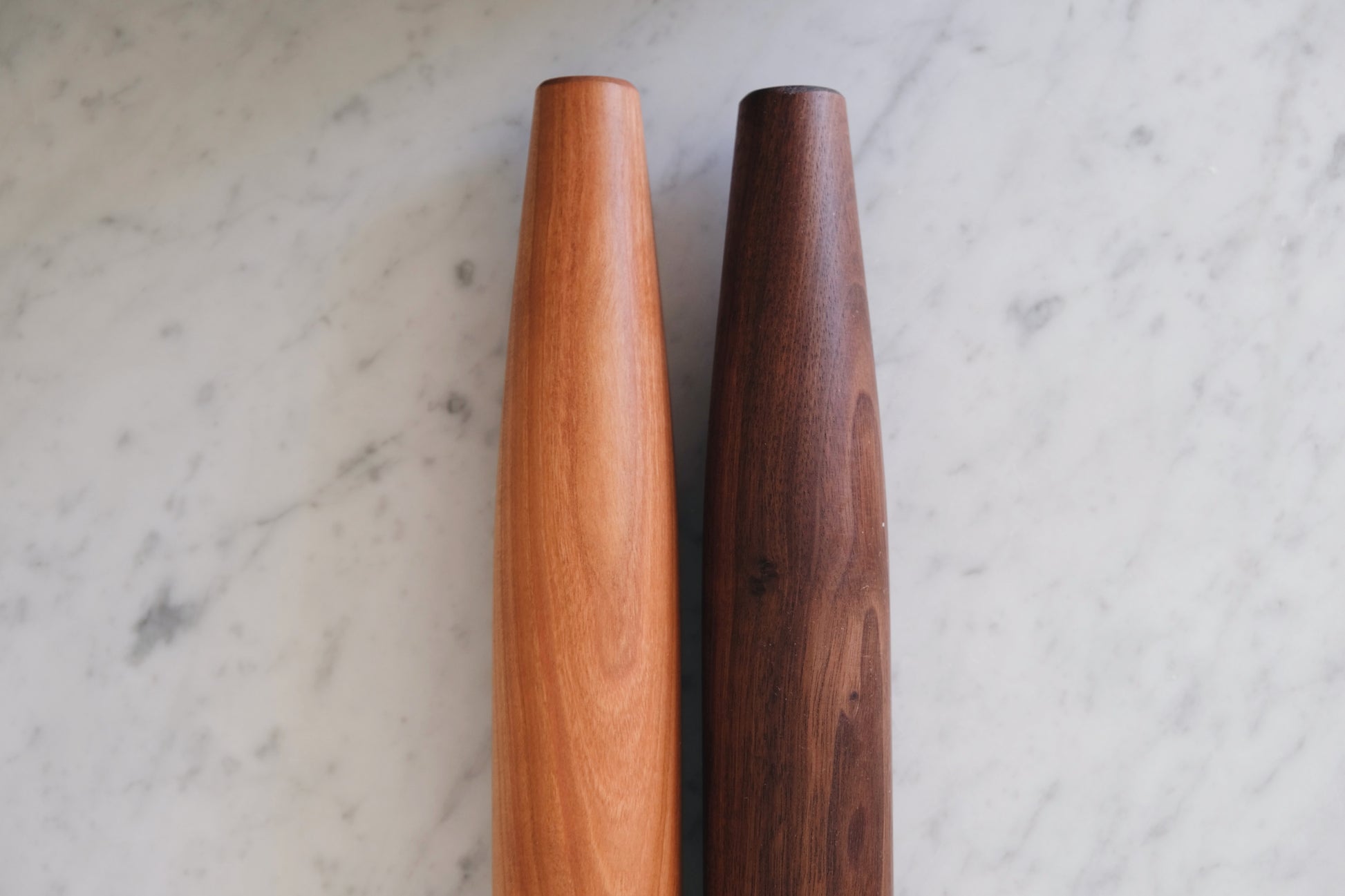 Close up view of walnut and cherry rolling pins