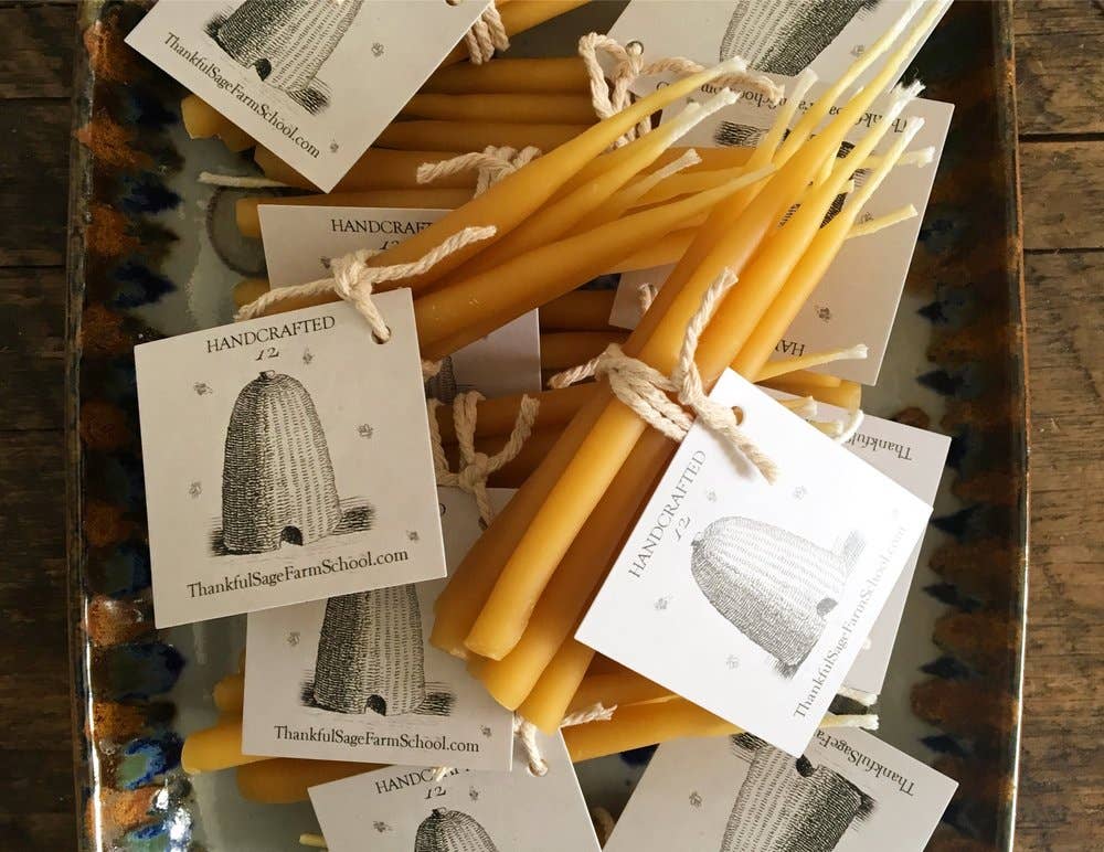 a bundle of natural beeswax birthday candles with tags and twine wrapping them