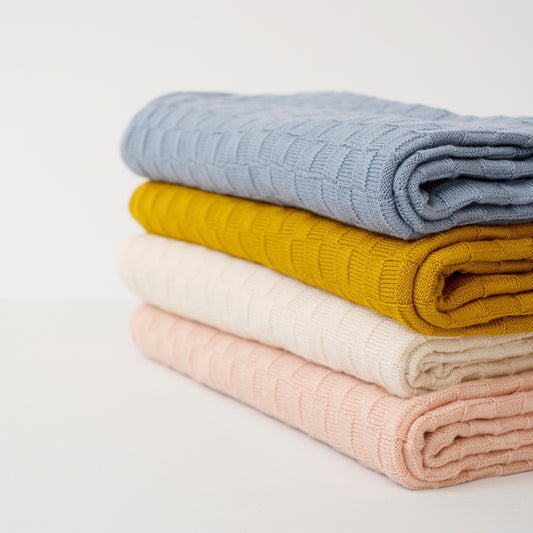 Stack of 4 organic cotton basketweave baby blankets