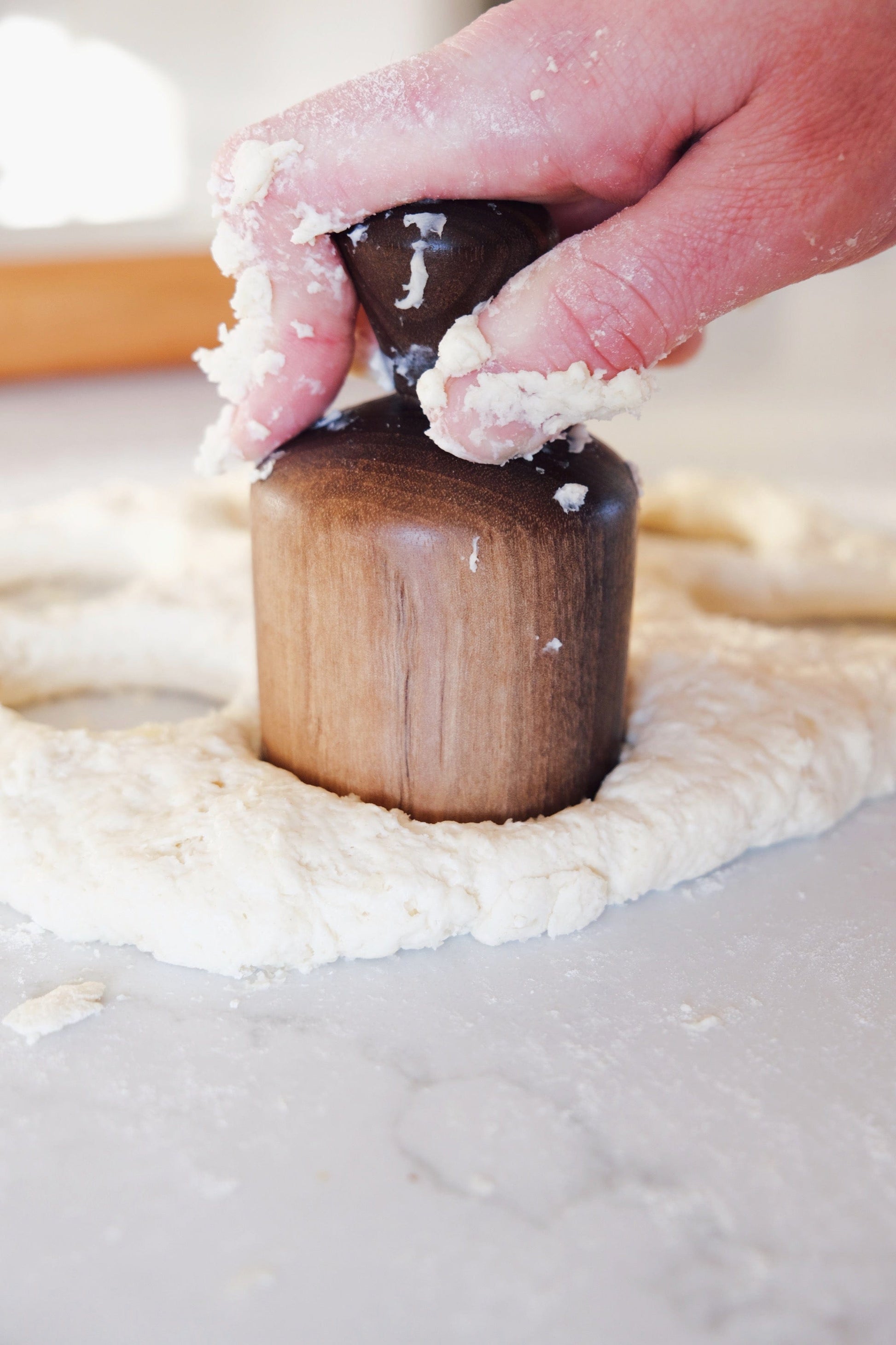 Walnut biscuit cutter cutting dough