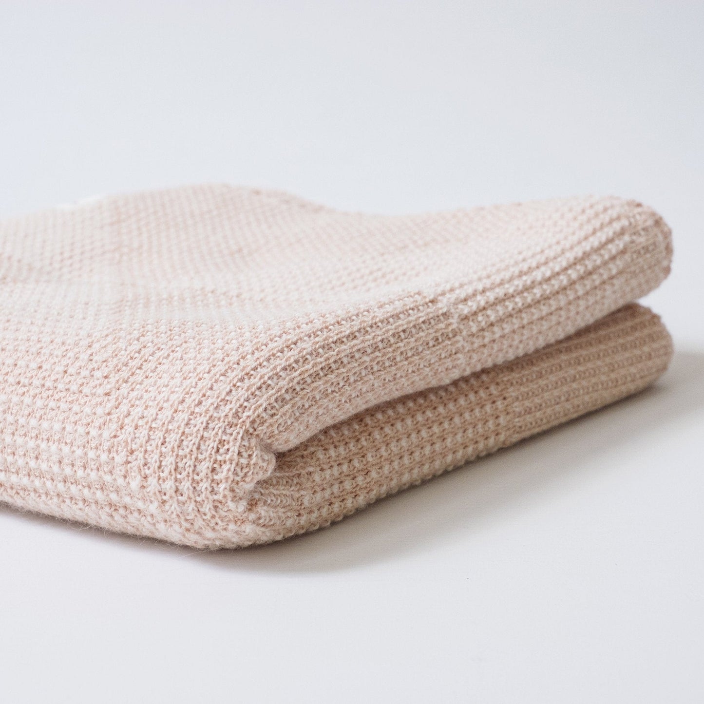 organic cotton and alpaca textured triangle baby blanket in peach