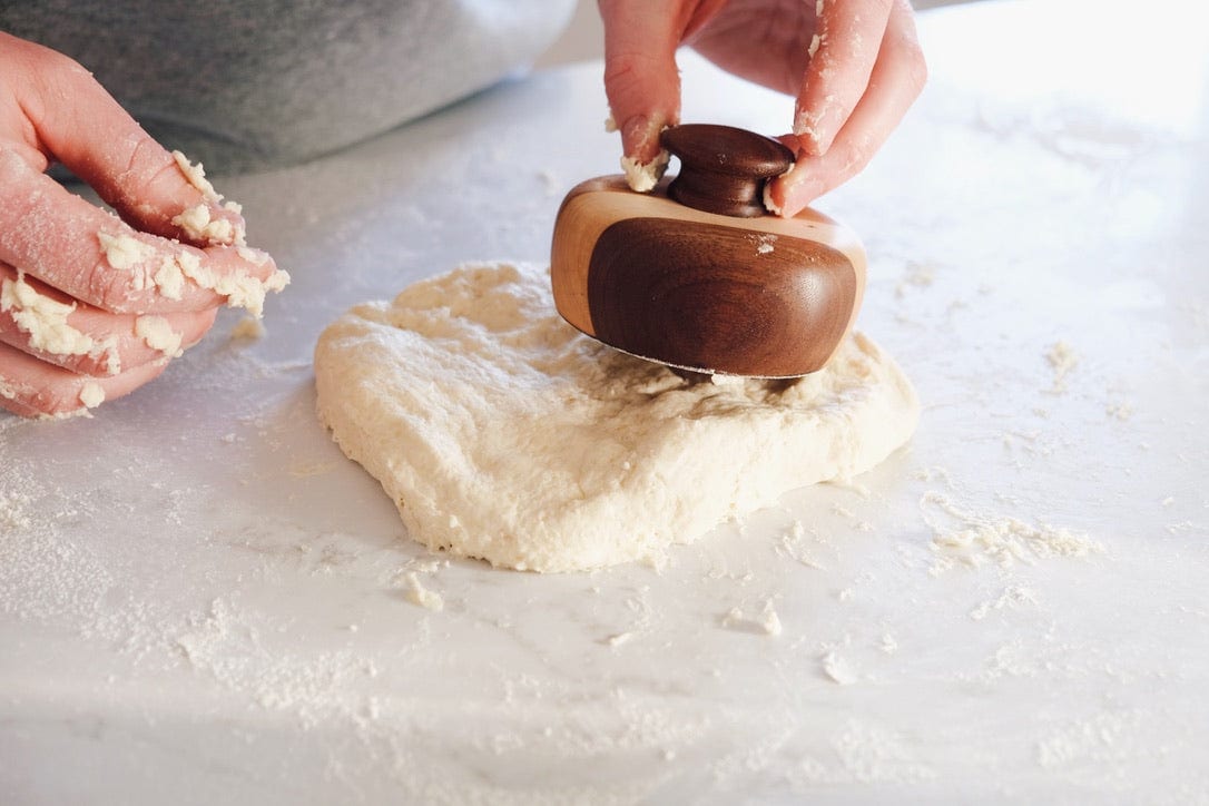 Using a large biscuit cutter on biscuit dough
