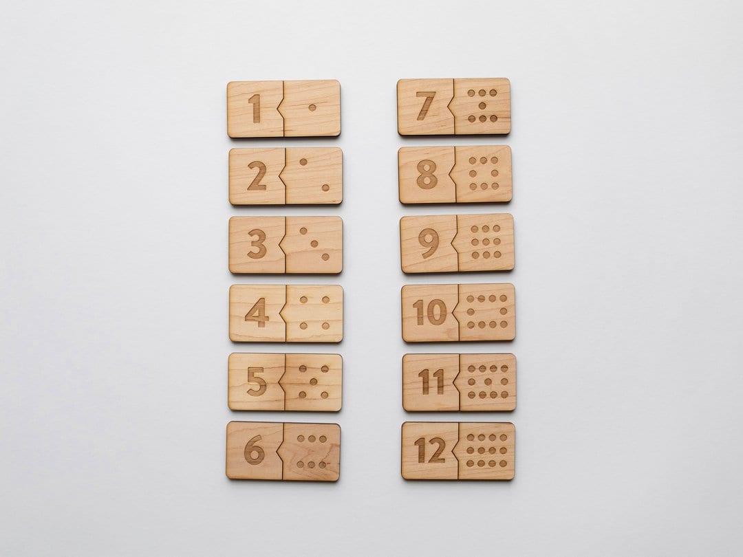 number and domino wooden puzzle pieces interlocked together