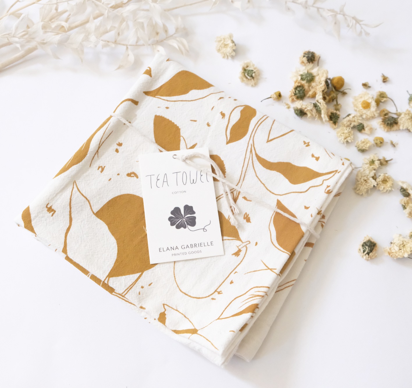 100% cotton pears tea towel folded with tag displayed