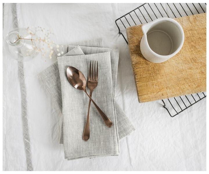 Oatmeal Linen Napkins on a table with with a fork and spoon on top