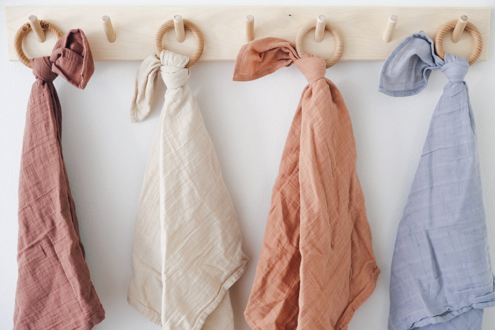 organic cotton baby loveys made in the usa hanging on a peg board