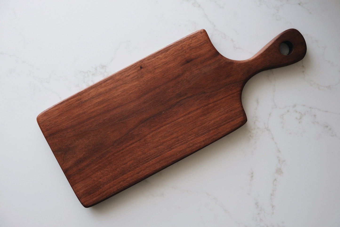 walnut serving board on countertop