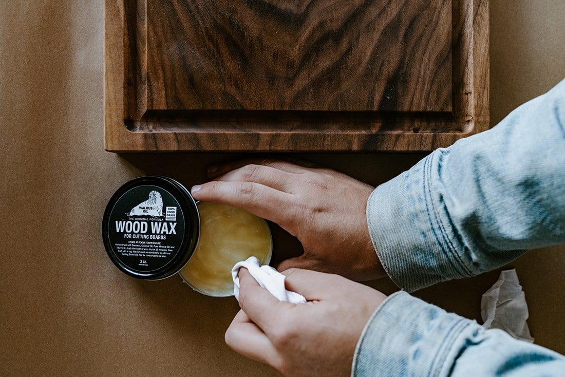 applying wood wax on a cutting board. 